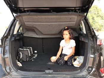 Portrait of girl in car trunk