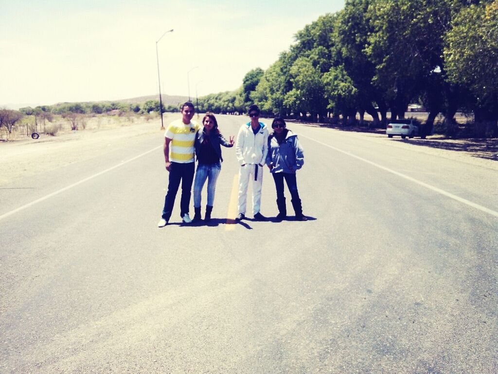 full length, lifestyles, togetherness, leisure activity, road, the way forward, tree, transportation, rear view, walking, men, casual clothing, sky, bonding, boys, day, friendship