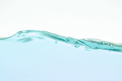 Close-up of water drop against blue background