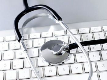 High angle view of stethoscope on computer keyboard