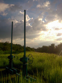 Scenic view of agricultural field against sky during sunset