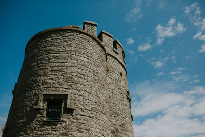 Low angle view of old building against blue sky