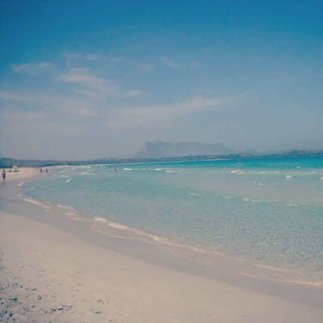 beach, sea, sand, water, shore, sky, scenics, tranquility, tranquil scene, beauty in nature, nature, blue, horizon over water, coastline, idyllic, cloud - sky, incidental people, outdoors, vacations, wave