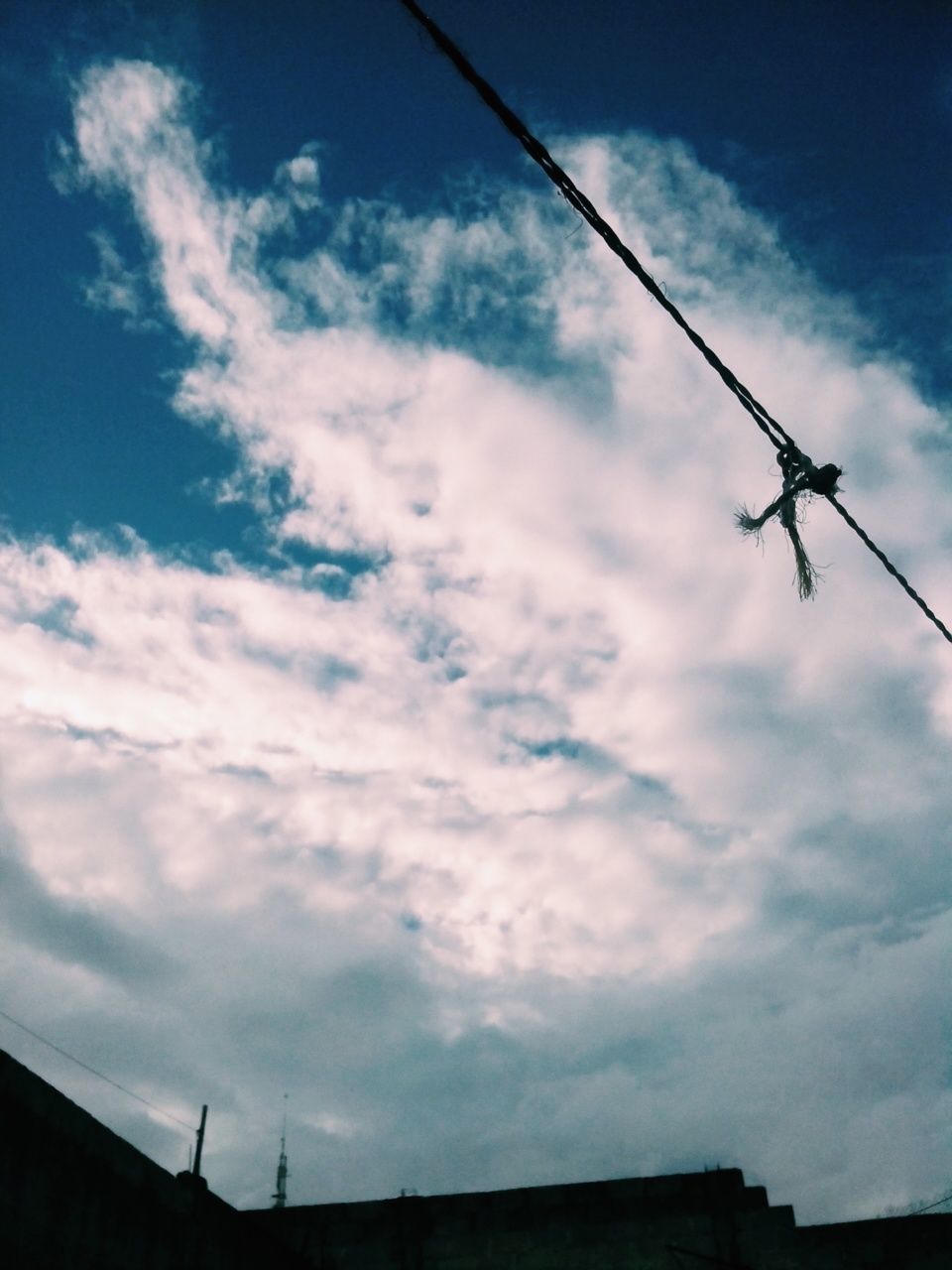 low angle view, sky, power line, cloud - sky, silhouette, electricity, fuel and power generation, technology, electricity pylon, power supply, cable, cloudy, cloud, built structure, connection, crane - construction machinery, outdoors, power cable, architecture, building exterior