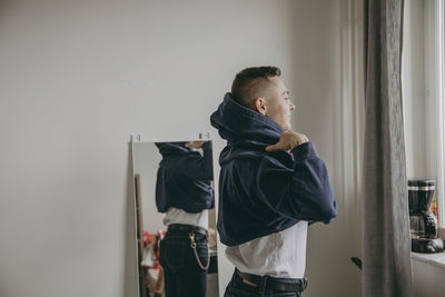 Side view of young man looking at home