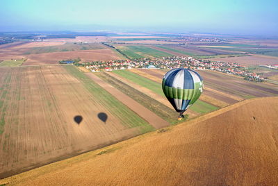 Hot air balloon in desert against sky