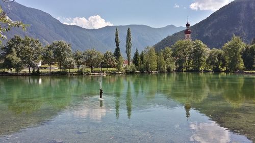 Scenic view of lake and mountains against sky