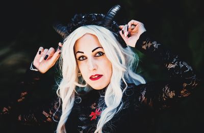 Portrait of beautiful woman in halloween costume standing outdoors