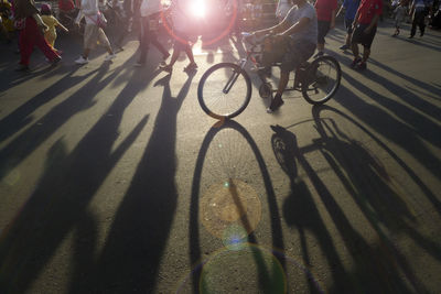 Low section of people riding bicycle on street