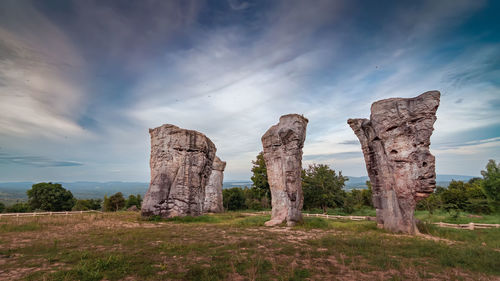 Rock formations on landscape against sky