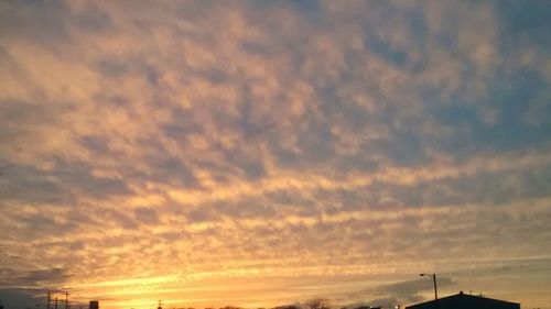 Low angle view of cloudy sky at sunset