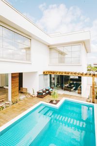 Swimming pool by building against sky