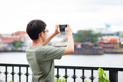 Rear view of man photographing