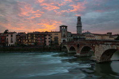 View of ponte pietra bridge at sunset