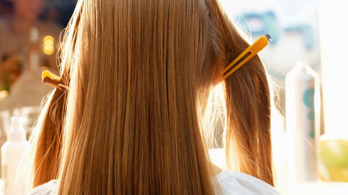 Rear view of girl with hairpins on hair