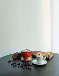 Coffee cup on table against wall