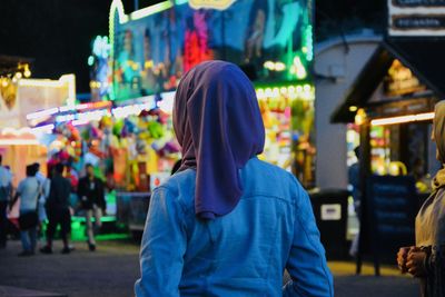 Man standing on street in city at night