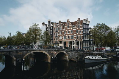 Arch bridge over river against sky