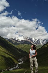 Man standing on mountain against sky