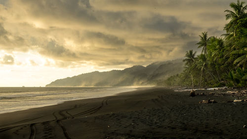 Scenic view of beach against sky during sunset