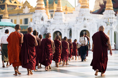 Rear view of people walking in temple
