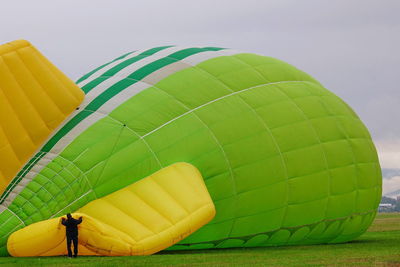 Multi colored hot air balloon flying against sky