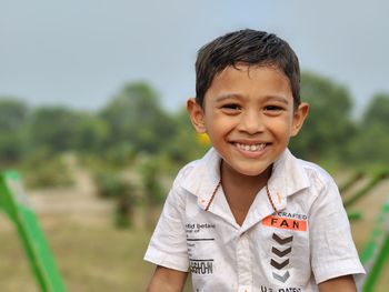 Portrait of a young indian boy smiling while looking at the camera