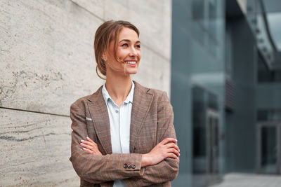 Portrait of smiling businesswoman standing outdoors