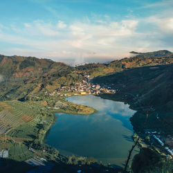 High angle view of lake against cloudy sky