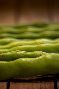 Close up of green beans on wooden table