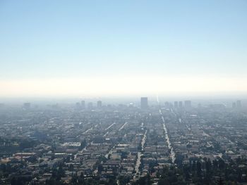 Aerial view of city against clear sky