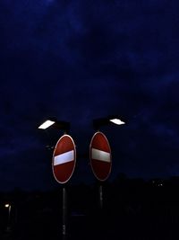 Low angle view of illuminated blue sky at night