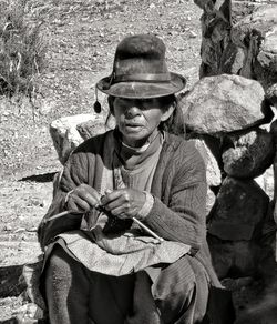 Full length of man holding hat