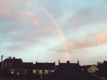 Rainbow over buildings in city