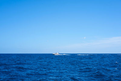 Scenic view of sea against clear blue sky