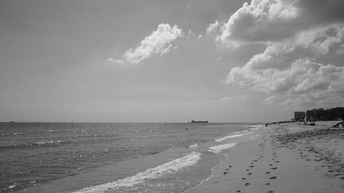 Panoramic view of beach against cloudy sky