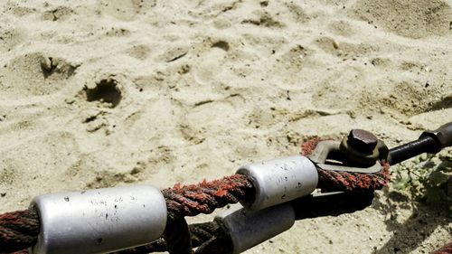 High angle view of rope above sandy beach during sunny day