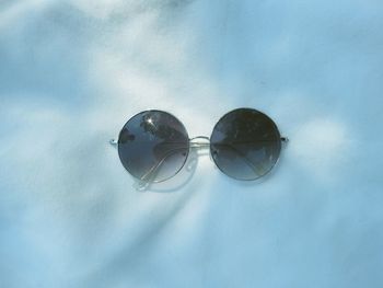 Close-up of sunglasses against sky