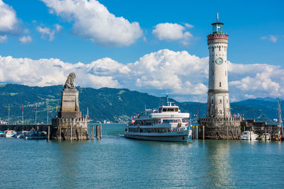 View of lighthouse by sea against sky