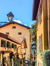 Street amidst buildings in town against clear blue sky