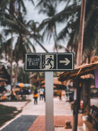 Road sign against trees