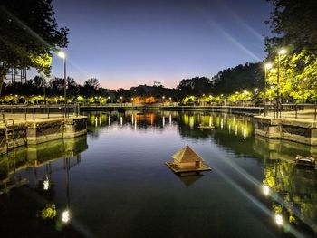 Scenic view of lake against sky at night