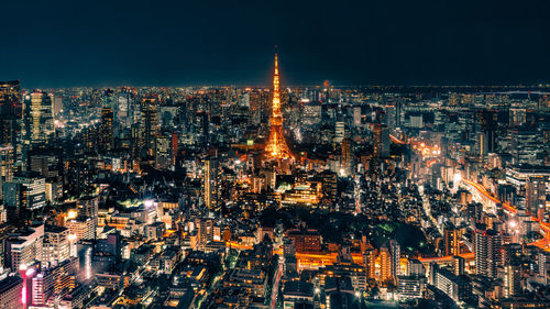 High angle view of city lit up at night