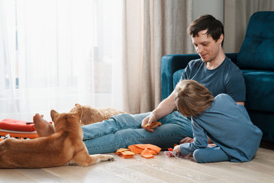 Friends and son on floor