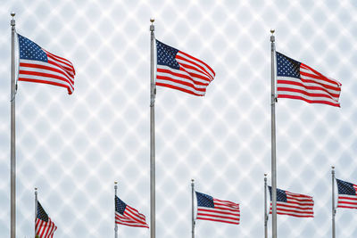 Low angle view of flag flags against sky