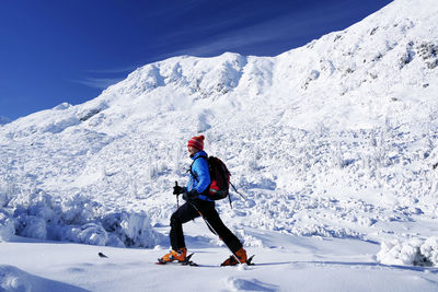Full length of person on snowcapped mountains during winter