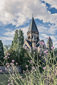 Temple by building against sky