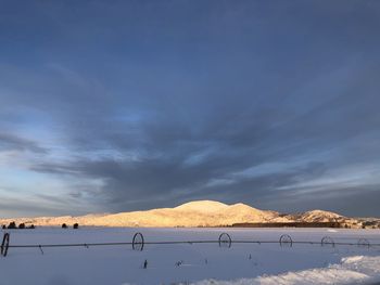 Scenic view of snowcapped mountains against sky during sunset