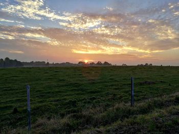 Scenic view of field against sky during sunset