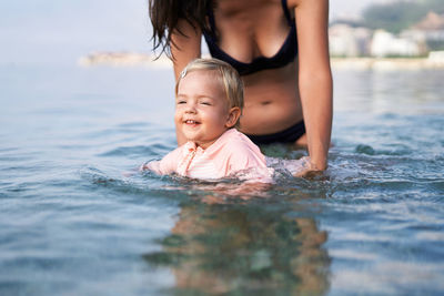 Young woman swimming in sea